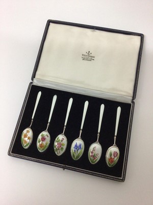 Lot 1 - Cased set of six sterling silver and enamelled tea spoons, each decorated with different flowers on a white ground