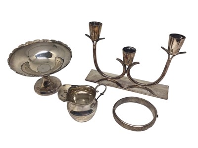 Lot 226 - Silver pedestal bonbon dish, small silver cream jug, silver bangle and a plated three branch candlestick