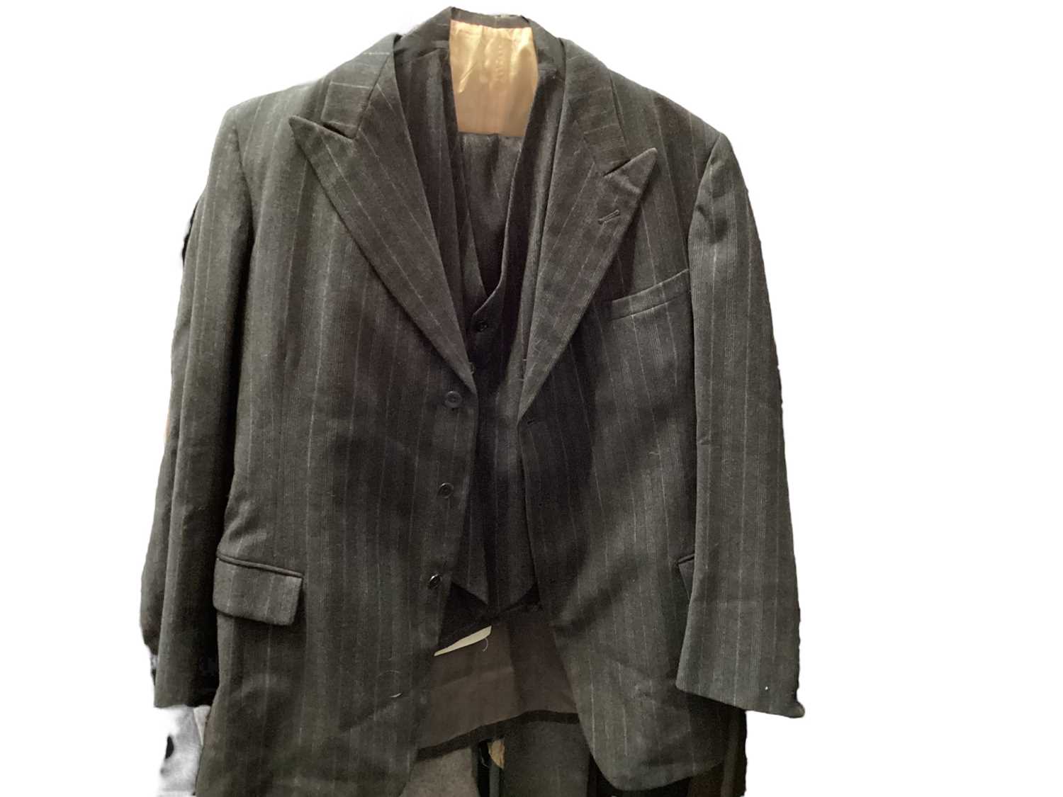 Lot 2110 - Early Burberrys men's gabardine mac with concealed buttons, button tab to cuffs and two-tone lining, Aquascutum men's grey herringbone wool overcoat and a grey pinstripe three piece suit , trouser...