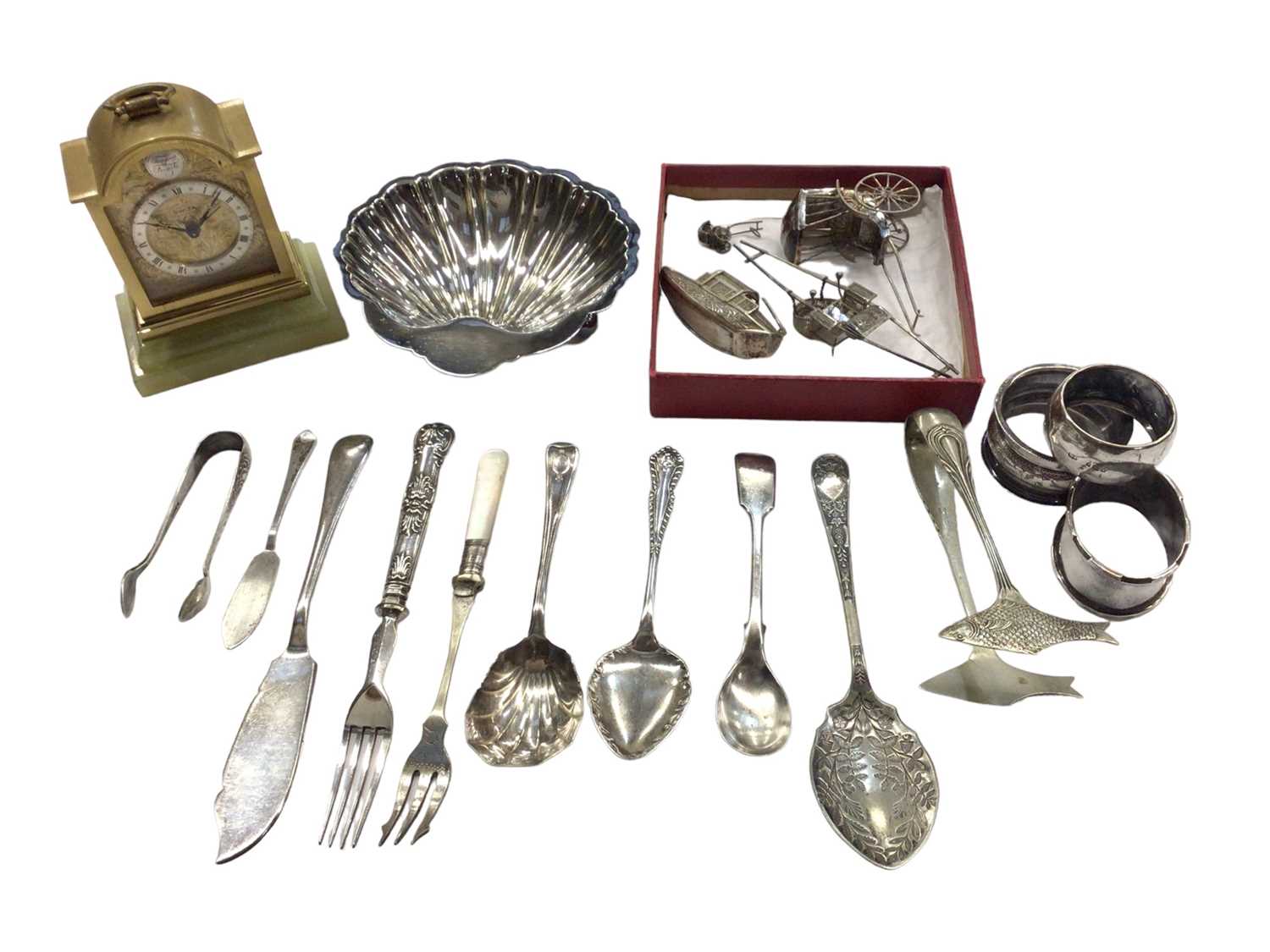 Lot 1001 - Chinese silver/white metal rickshaws, rowing boat etc, three silver napkin rings, plated ware and a bedside clock
