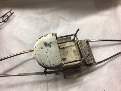Lot 1001 - Chinese silver/white metal rickshaws, rowing boat etc, three silver napkin rings, plated ware and a bedside clock