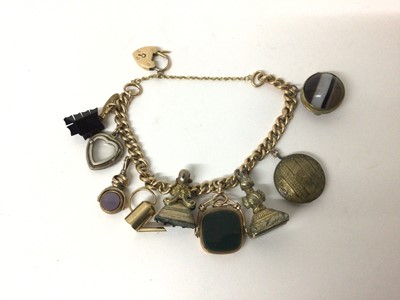 Lot 5 - 15ct gold curb link bracelet with a collection of antique gilt metal charms