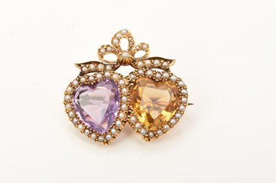 Lot 429 - Edwardian amethyst and citrine double sweetheart brooch