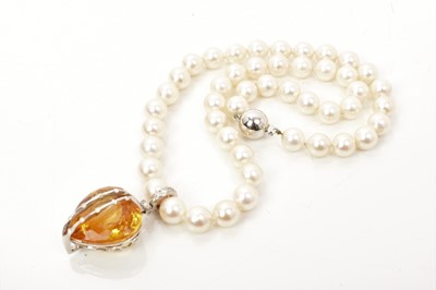 Lot 430 - Good quality citrine and diamond heart shaped pendant on a string of cultured pearls, with a large heart shaped citrine weighing approximately 37.62cts, measuring approximately 23mm x 22.7mm x 13.6...