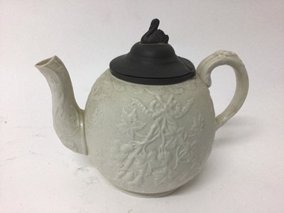 Lot 17 - A group of five 19th century English teapots, including one dark blue Wedgwood jasperware, one lilac jasperware, and three other relief-moulded examples