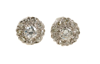 Lot 502 - Pair of diamond cluster earrings with a central round brilliant cut diamond surrounded by a border of old cut diamonds in white gold setting