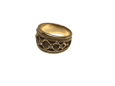 Lot 49 - 18ct gold and diamond set ring with a lattice design and rope twist border, size O½