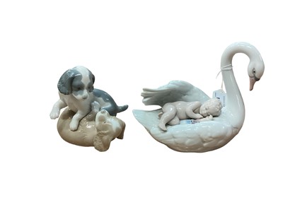 Lot 1238 - Lladro porcelain ornament of a Swan carrying a sleeping child, Nao ornament of two dogs, and other figures