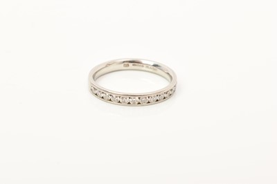 Lot 662 - Platinum and diamond half eternity ring retailed by Pravins