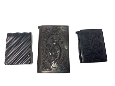 Lot 53 - Large Victorian moulded Vulcanite Vesta case decorated with fisherman and flower girl 7 x 4.5mm, another with striped decoration and an Irish bog oak Vesta case (3)