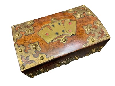 Lot 2558 - Victorian burr wood playing card box, with decorative brass mounts and hinged cover with coloured Heart, Spade and Diamond brass card emblems. 22cm overall width.