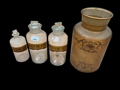 Lot 2580 - Three Victorian gilt labelled chemist jars, together with a frosted glass jar with gilt decoration