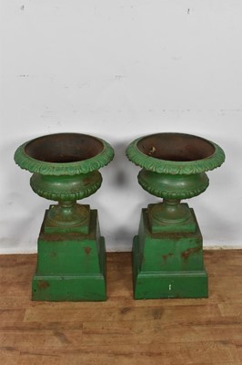 Lot 1294 - Pair of Victorian green painted cast iron urns on stands