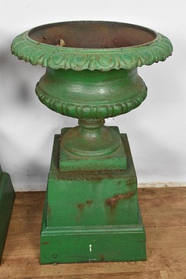 Lot 1294 - Pair of Victorian green painted cast iron urns on stands