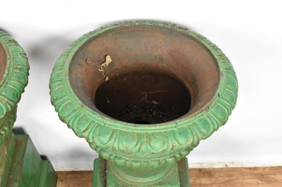 Lot 1294 - Pair of Victorian green painted cast iron urns on stands