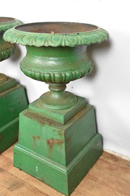 Lot 1294 - Pair of Victorian green painted cast iron urns on stands