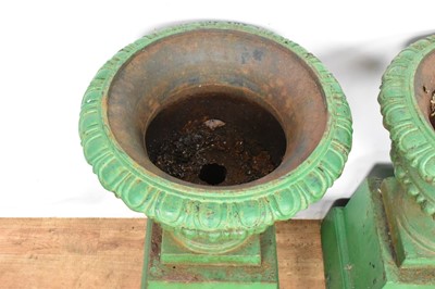 Lot 1294 - Pair of Victorian green painted cast iron urns on stands