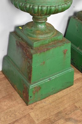 Lot 1294 - Pair of Victorian green painted cast iron urns on stands