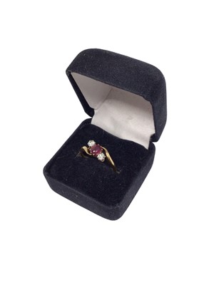 Lot 98 - 18ct gold ruby and diamond three stone cross over ring