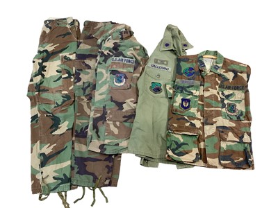 Lot 760 - Collection of mainly American Cold War era camouflage jackets and other uniform, some with patches and insignia (3 boxes)