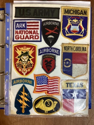 Lot 767 - Four albums of American Air Force, US Navy and US Army cloth and metal badges including rank insignia (4 albums)