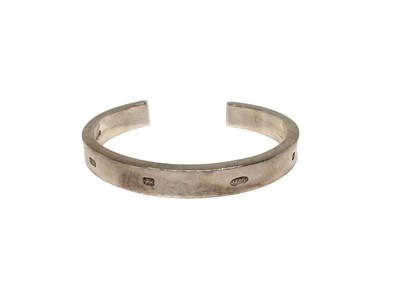 Lot 137 - Silver torque bangle with large hallmark decoration (Birmingham 2003)