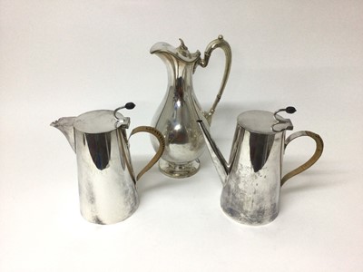 Lot 590 - Asprey silver plated coffee pot and matching hot water pot with rattan covered handles and coffee bean formed handles, 21cm high, together with a silver plated water pitcher (3)