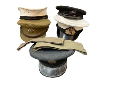 Lot 815 - Two boxes of assorted militaria to include various caps, leather holsters, sam browne belt and other items (2 boxes).