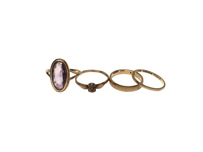 Lot 151 - Four 9ct gold rings to include two wedding bands, diamond single stone in illusion setting and amethyst cocktail ring