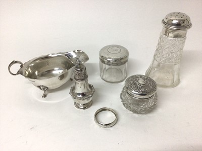 Lot 98 - Group of silver to include a silver topped cut glass sugar castor, sauce boat, pepperette, napkin ring and two silver topped toiletry jars, all at 7ozs