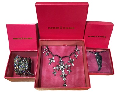 Lot 158 - 1980s Butler & Wilson multi-coloured diamanté novelty snake wrap bangle, large cross pendant necklace and a black wing necklace, all boxed (3)