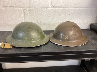 Lot 825 - Second World War British Military MKII Steel Helmet with green painted camouflage finish and 'FS' to front, with chinstrap and liner, together with another similar MK II Steel Helmet with no liner