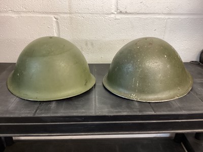 Lot 826 - Second World War British military MK III steel helmet with green camouflage finish, with liner and chin strap, together with another similar MK III steel helmet (2)