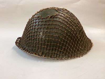 Lot 849 - British Mk11 steel helmet with late Second World War granular brown interior paint finish, green external paint finish, complete with liner, chinstrap and original net.  Service number 23407973 ins...