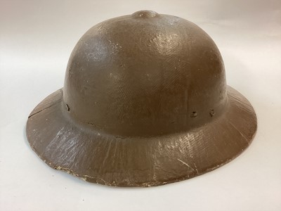 Lot 872 - Rare Second World War Japanese civilian protective helmet made of fibre or papier mache, complete with headband, cross-straps and chinstrp.  Excellent condition including ochre paint finish