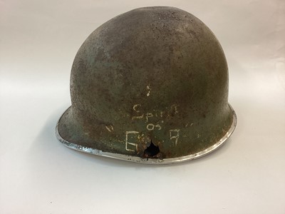 Lot 873 - US M1 steel helmet body bearing projectile damage and graffitti