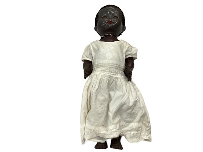 Lot 1771 - Four black dolls including pedigree, some clothing.