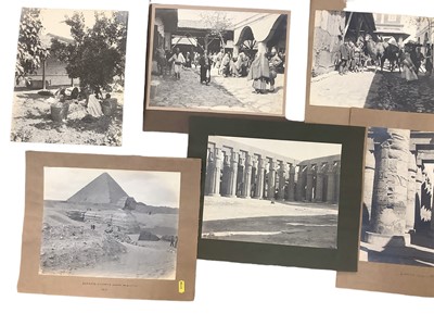 Lot 1491 - Group of 1911 mainly large mounted photographs Egypt including Temple at Luxor, Courtyard of Inn Nazli, market Nazli, busy road to the Pyramids, Nile Boats, Pylon Gates Karnak and others.