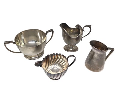 Lot 269 - Art deco silver two handled sugar bowl (London 1937), two Victorian silver cream jugs and an Edwardian silver cream jug (4)