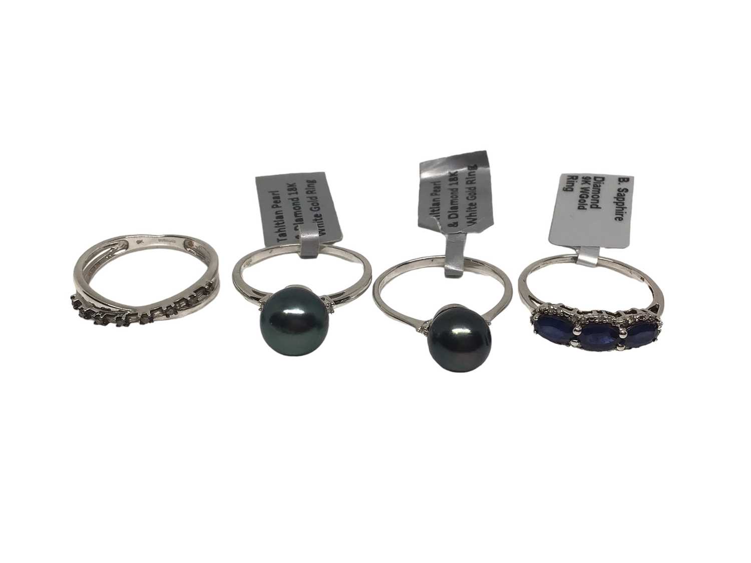 Lot 298 - Two 18ct white gold Tahitian cultured black pearl and diamond rings, and two 9ct gold diamond and gem-set dress rings (4)
