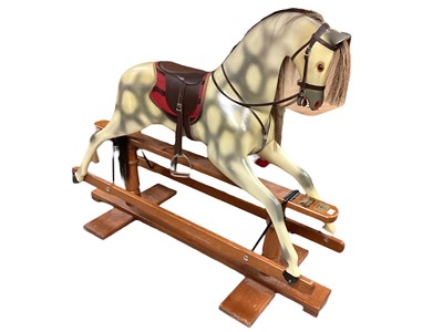 Lot 2012 - Haddon Children's rocking horse with cantilever action, on pine base. The Dapple horse with real horse hair mane and tail and leather saddle.