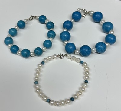 Lot 47 - Three contemporary pearl and turquoise bead bracelets with silver clasps