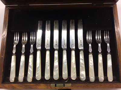 Lot 1073 - Set of six silver fruit knives and forks with mother of pearl handles in fitted wooden case