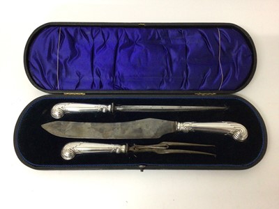 Lot 136 - Good quality late Victorian silver handled carving set with pistol grips decorated with scrollwork ( Sheffield 1899) in fitted case