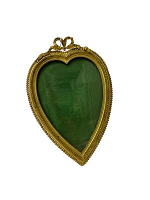 Lot 138 - Good quality Edwardian ormolu heart-shaped photograph frame with ribbon cresting and beaded border with easel back 18.5 x 13cm