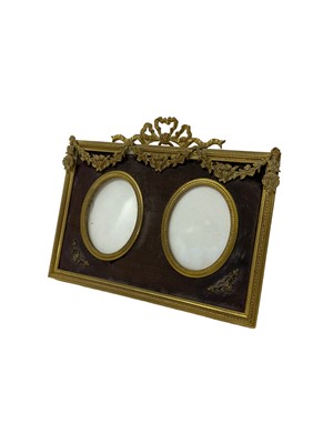 Lot 139 - Edwardian ormolu twin photograph frame with ribbon cresting and floral swag decoration with easel back 13.2 x 16.5cm