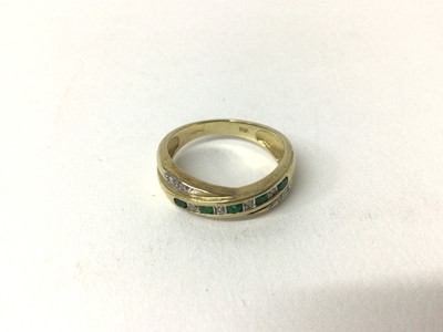 Lot 169 - Emerald and diamond ring with a cross-over design