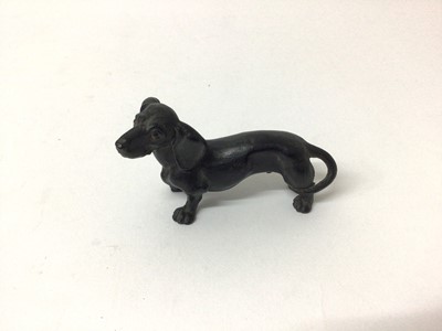 Lot 123 - Antique carved wooden model of a Dachshund with painted eyes and naturalistically carved body, 9cm long x 5cm high.