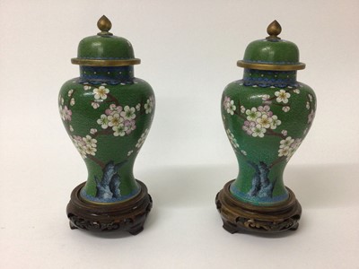 Lot 161 - Pair Chinese cloisonne vases and covers with prunus and bird decoration on pierced wooden stands 25cm high overall