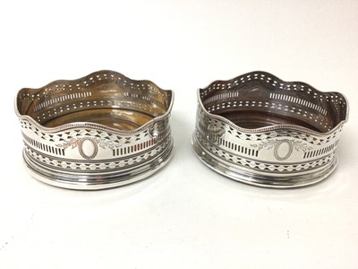 Lot 209 - Pair of Victorian silver plated wine coasters with shaped and pierced borders with turned wooden bases